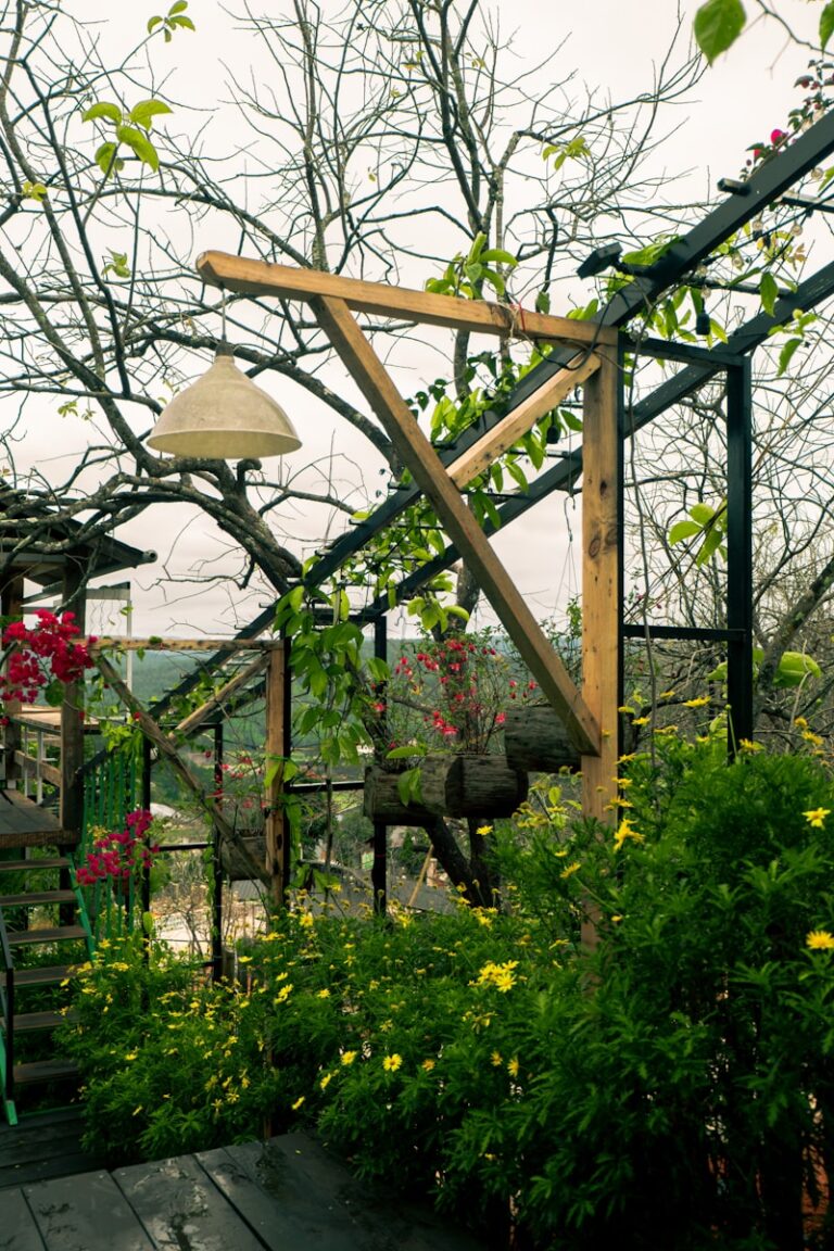 a wooden deck surrounded by plants and flowers