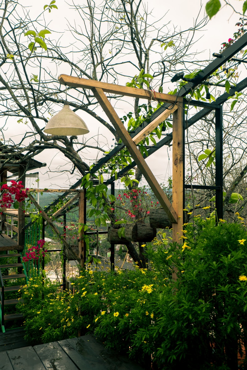 a wooden deck surrounded by plants and flowers